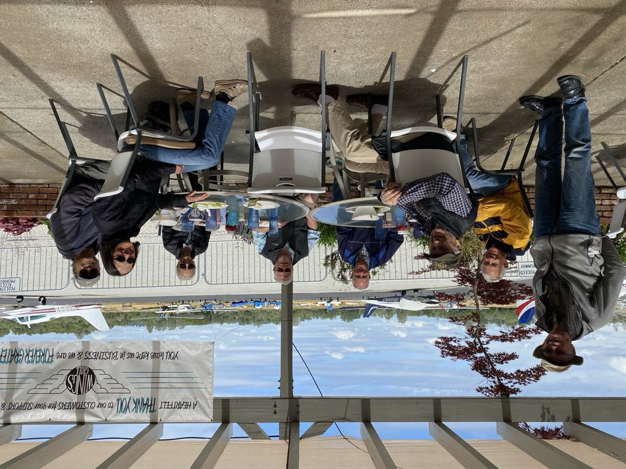 Members gathered around an airplane after a group flight